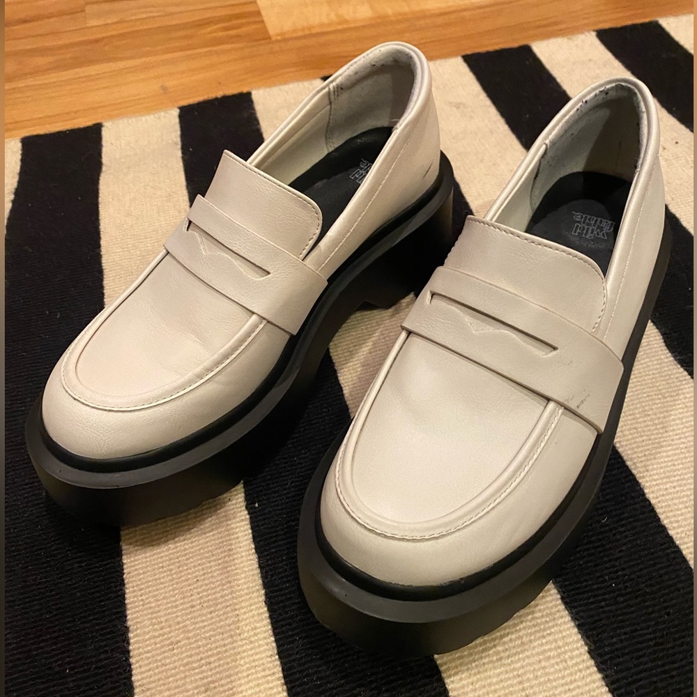 White and black lug sole penny loafers